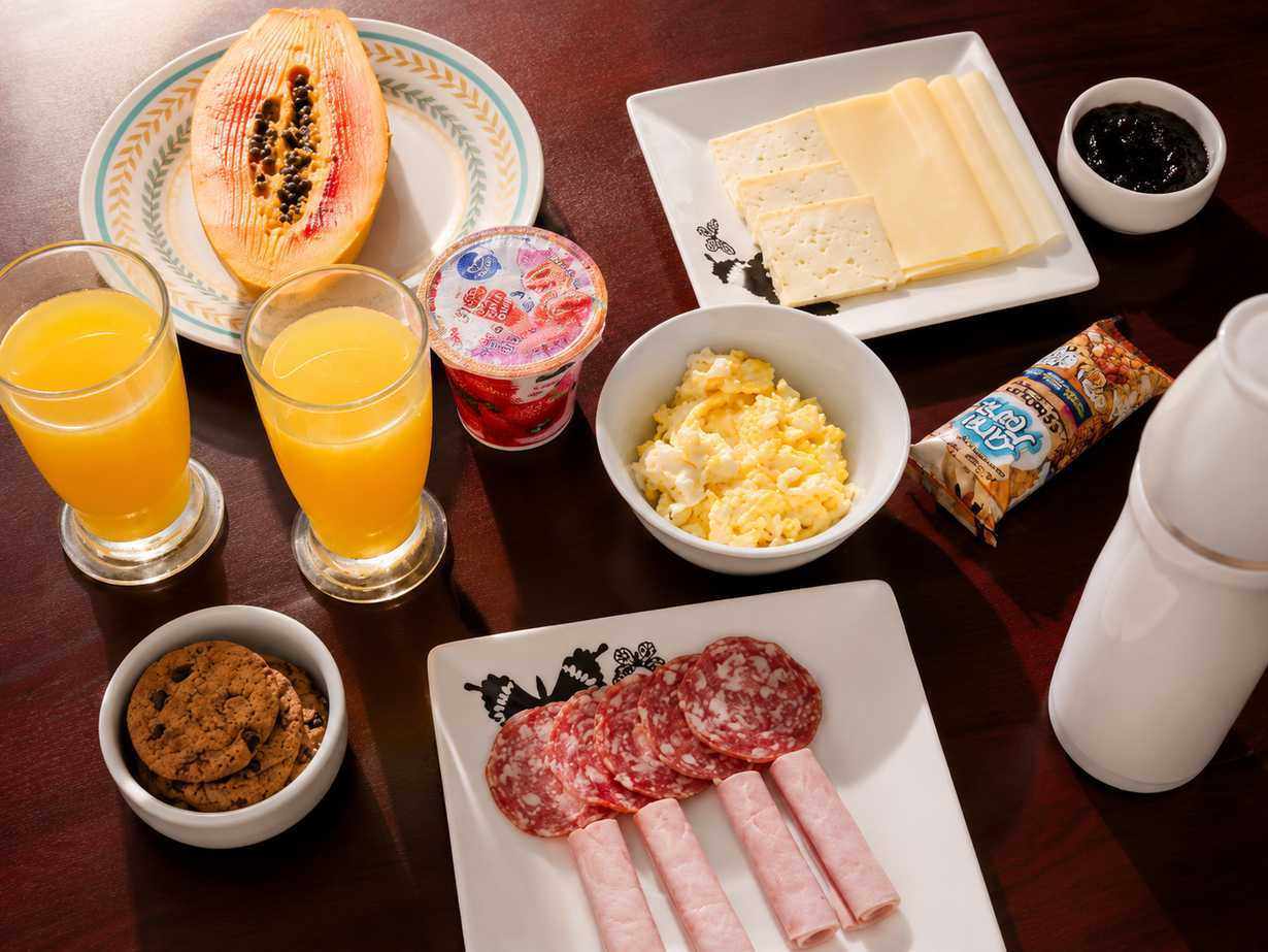 Fresh breakfast spread with fruit, cheeses, juices and morning dishes