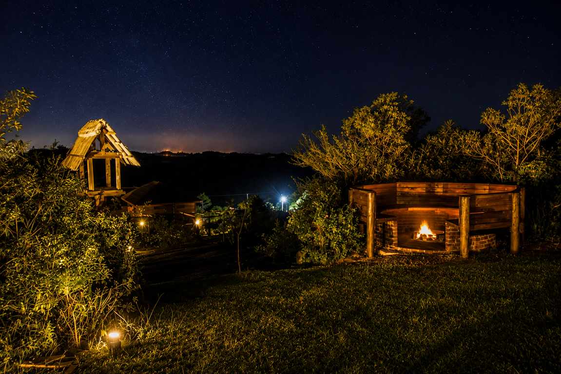 Outdoor brick fire pit glowing beneath a starlit sky