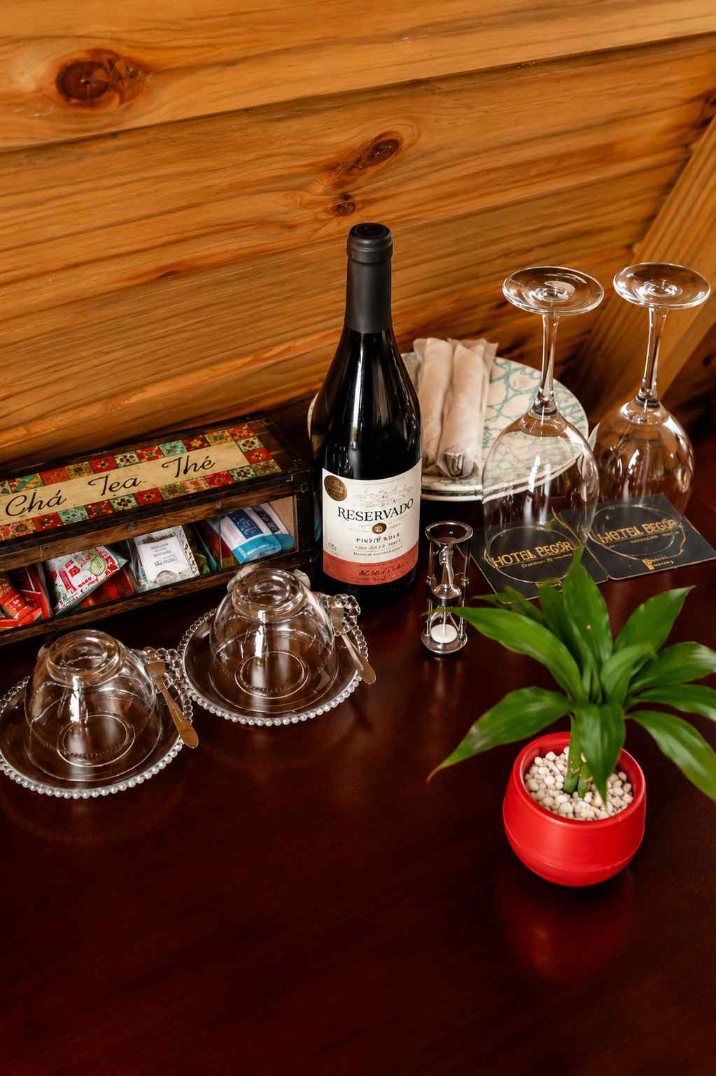 Wine, tea selection and welcome amenities styled on a wooden counter